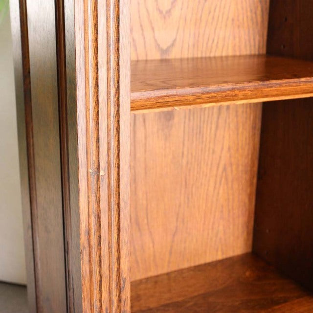 Vintage teak mid-century British cabinet with visible wood grain and clean lines, showcasing the oak interior shelf and.