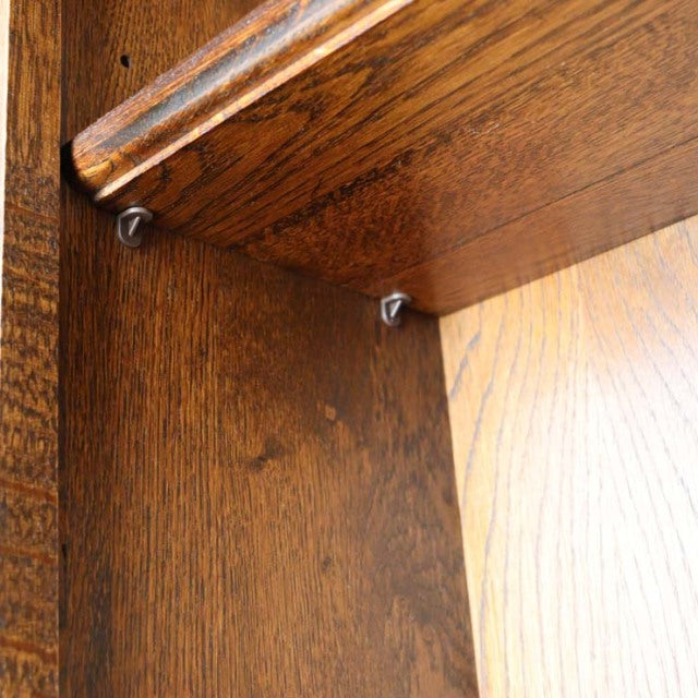 Close-up of vintage teak cabinet interior showing rich wood grain and mid-century British craftsmanship with sturdy joinery.