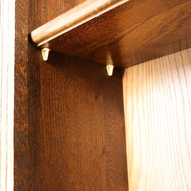 Close-up of vintage teak British mid-century cabinet corner showing rich wood grain and precise joinery details.