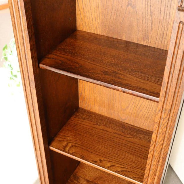 Vintage teak British mid-century cabinet shelves showing rich wood grain and warm oak tones.