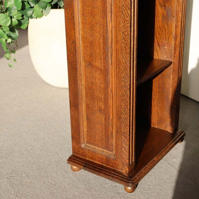 Vintage teak cabinet with rich wood grain, British mid-century style, decorative molding, and rounded feet, showing warm.