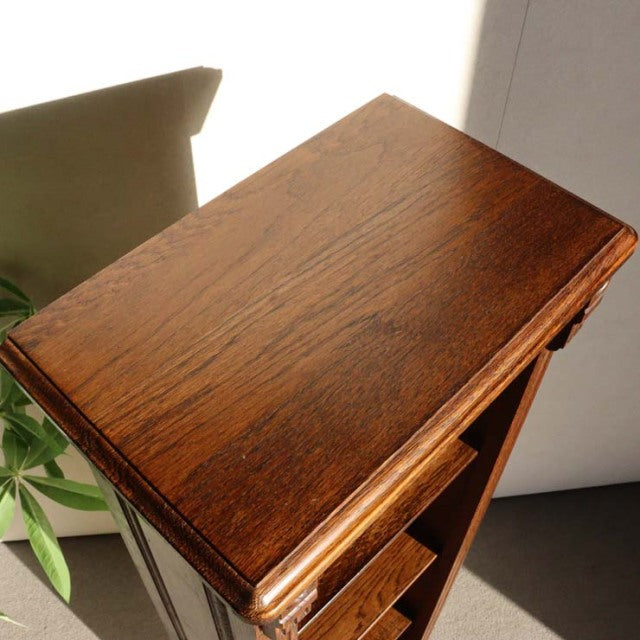 Vintage teak cabinet with rich wood grain, mid-century British design, sleek legs, and clean lines.