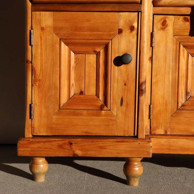 Vintage teak sideboard door with mid-century British design, natural wood grain, rounded turned legs, and black round knob.