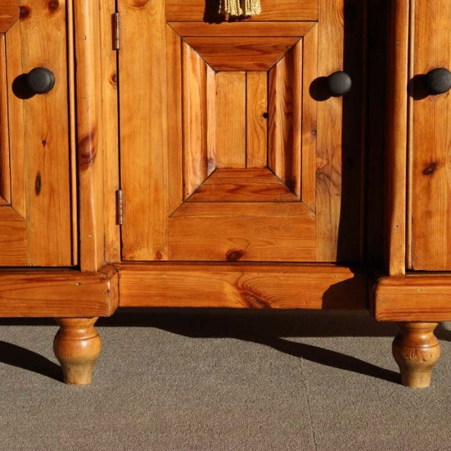 Mid-century vintage British sideboard in rich teak with warm wood grain and turned wooden legs.