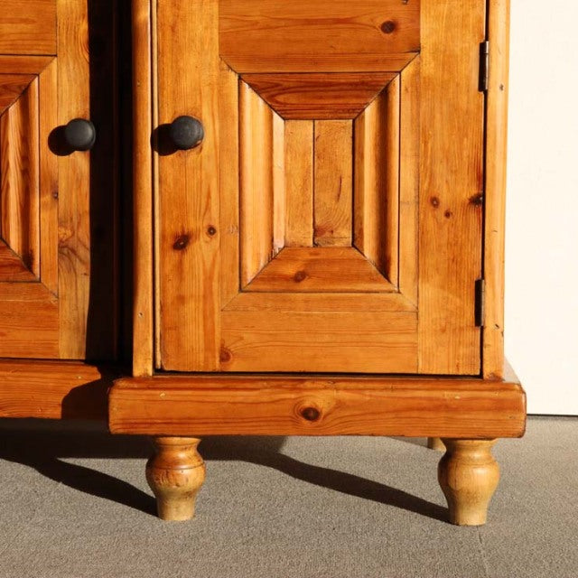 Vintage teak sideboard with British mid-century design, rich wood grain, and turned wooden legs.