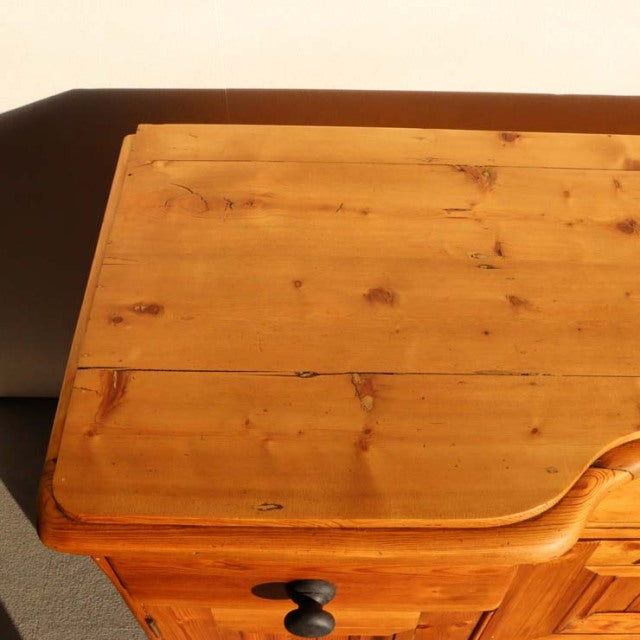 Vintage teak British mid-century sideboard corner with natural wood grain and rounded edges on Denmark-style legs.