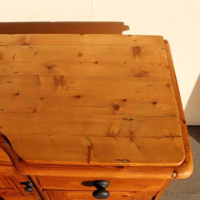 Vintage teak sideboard top with warm honey tones, natural wood grain, and smooth rounded edges, reflecting mid-century.