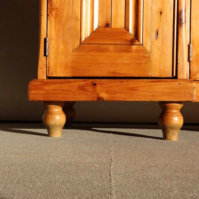 Vintage teak sideboard corner with British mid-century style, showcasing rich wood grain and turned legs.