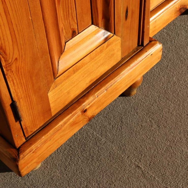Close-up of vintage teak sideboard corner showing warm wood grain and handcrafted British mid-century detailing on sturdy.
