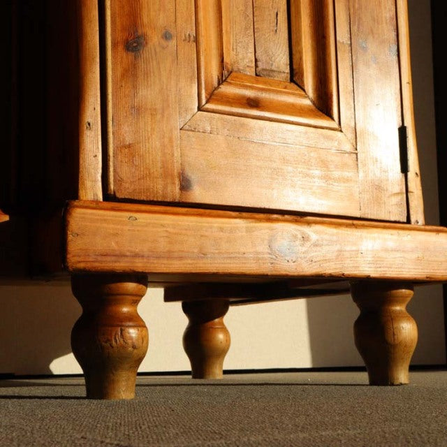 Vintage teak sideboard legs with rich wood grain, mid-century British design, turned wooden feet from Denmark influence.