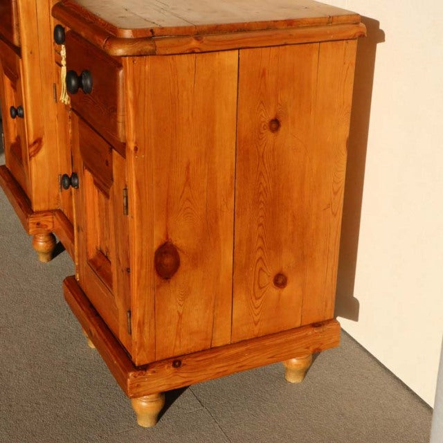 Vintage teak sideboard in mid-century British style with rich wood grain, rounded corners, and turned legs.