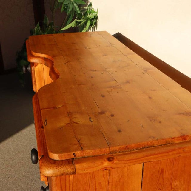 Vintage teak sideboard with warm honey finish, showcasing natural wood grain and knots, solid mid-century British design.