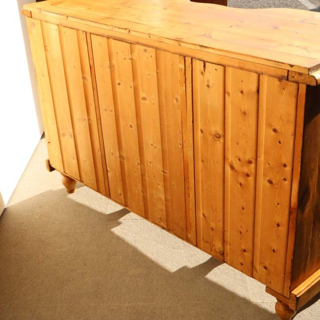 Vintage teak mid-century sideboard with British-Denmark influence, showcasing rich wood grain and vertical slat doors on.