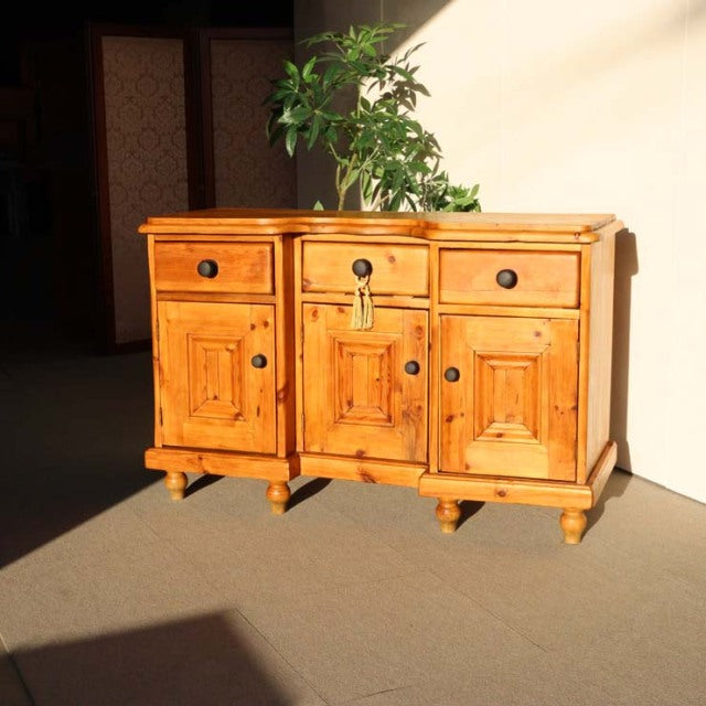 Vintage teak sideboard with detailed wood grain, mid-century British design, and classic round knobs.