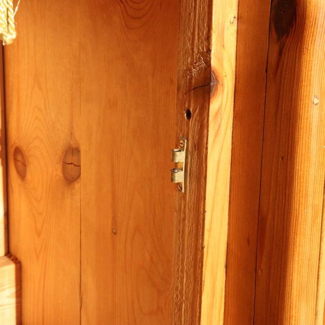 Close-up of vintage teak wood sideboard edge showing warm grain patterns and mid-century British craftsmanship details.