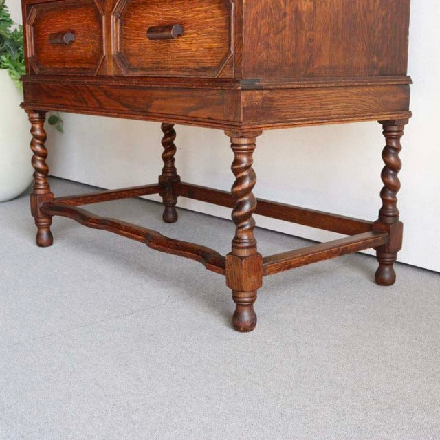 Vintage British teak cabinet legs with twisted spindle design, showcasing rich wood grain and mid-century craftsmanship from .