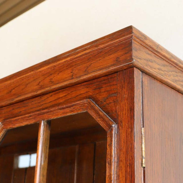 Close-up of vintage teak British mid-century cabinet corner showing rich wood grain and detailed joinery.