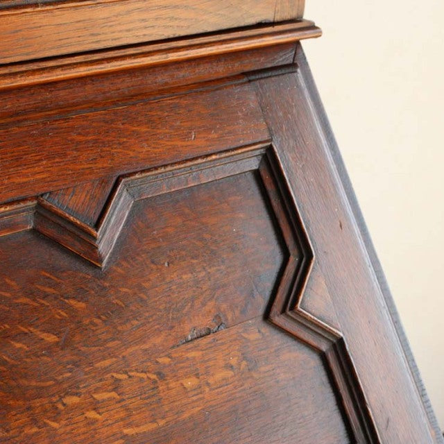 Close-up of vintage British teak cabinet door showcasing rich wood grain and mid-century geometric panel design.