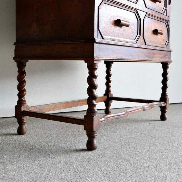 Mid-century British vintage teak cabinet legs with twisted barley twist design and stretcher bars, rich wood grain visible.
