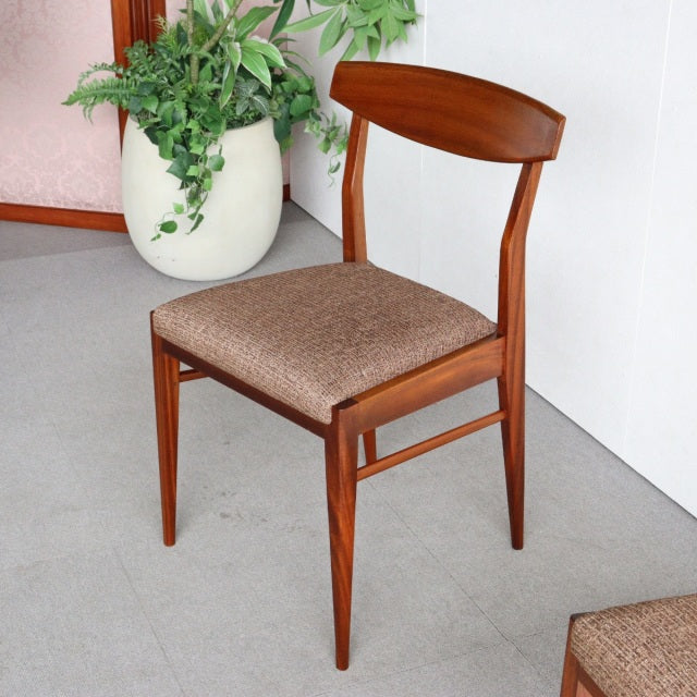 Vintage mid-century McIntosh teak dining chair from Denmark with curved backrest, tapered legs, and textured fabric seat.