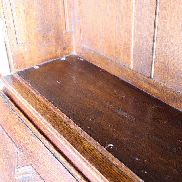 Close-up of vintage British teak mid-century cabinet shelf with visible wood grain and warm patina.