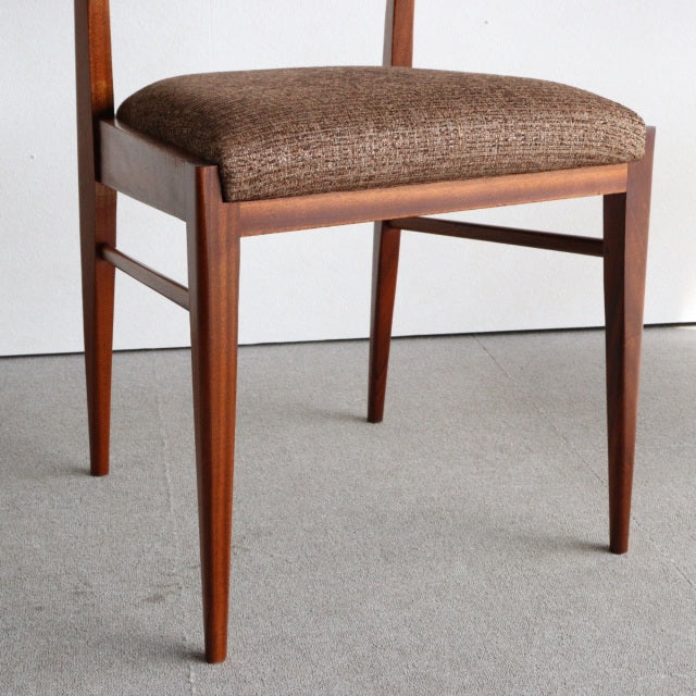 Vintage teak dining chair by McIntosh featuring mid-century British design, tapered legs, and textured brown upholstered.