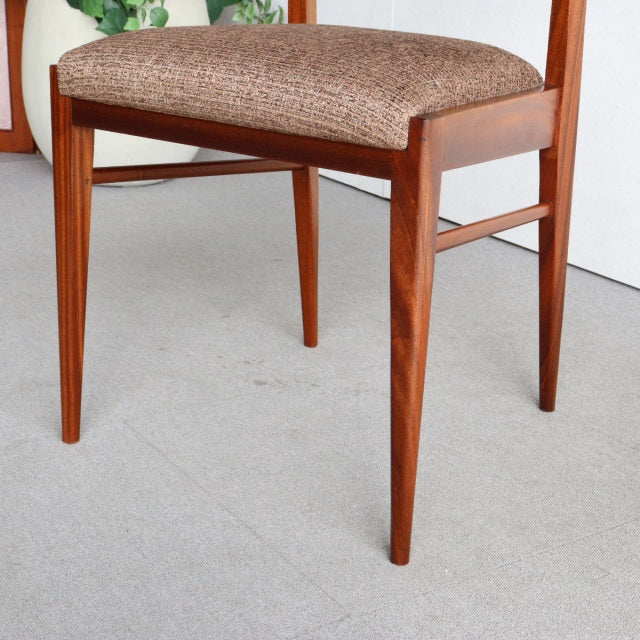 Mid-century vintage McIntosh dining chair in teak with tapered legs and textured brown fabric seat, British-Danish style.