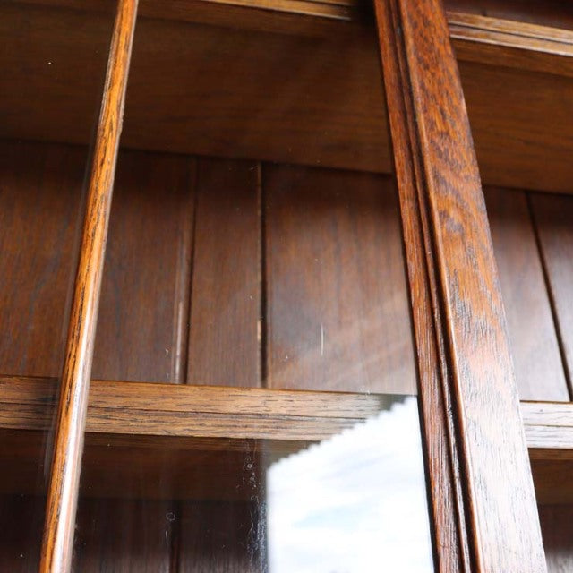 Vintage British teak cabinet from the 1930s with rich wood grain and vertical frame details.