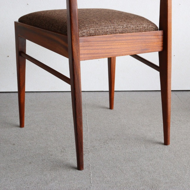 Mid-century British McIntosh dining chair in vintage teak with tapered legs and textured brown upholstered seat.