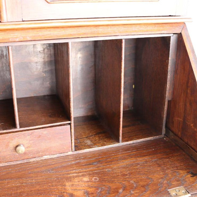 Vintage teak mid-century British cabinet interior with multiple compartments and small drawer, rich wood grain details from.