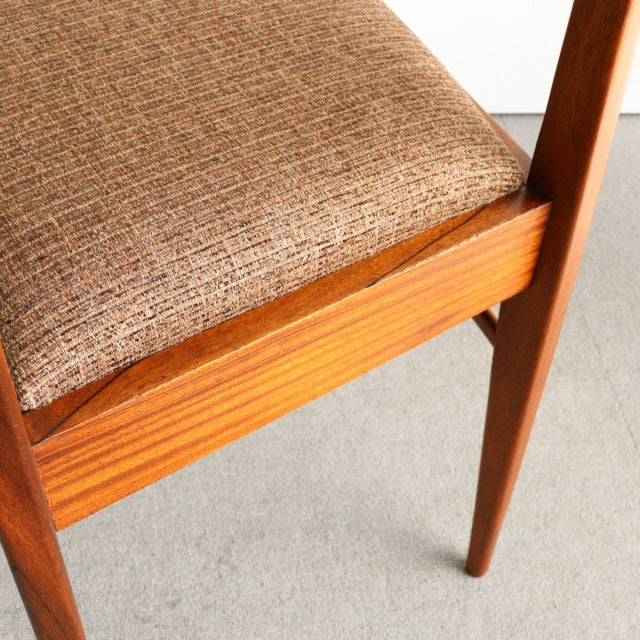 Close-up of vintage teak mid-century dining chair by McIntosh showing rich wood grain, tapered British-style legs, and.