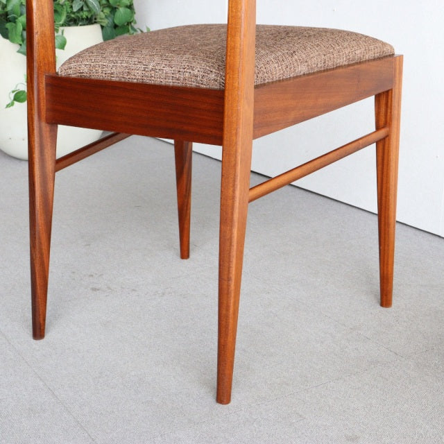 Vintage McIntosh teak dining chair with mid-century British design, tapered legs, and textured brown fabric seat.
