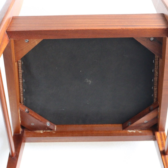 Underside view of vintage teak dining chair by McIntosh, showcasing sturdy mid-century British craftsmanship and wood grain.