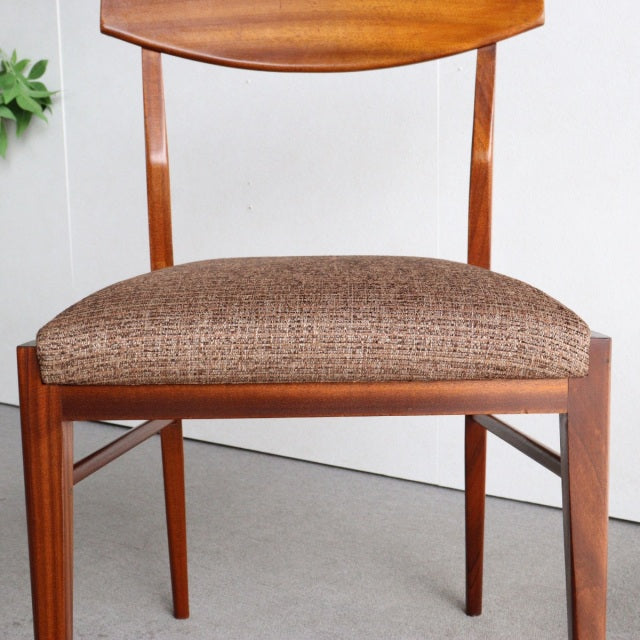 Vintage McIntosh mid-century teak dining chair from Britain with textured brown fabric seat and gently curved backrest.