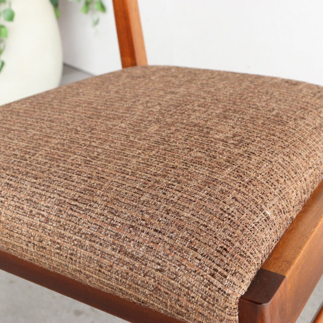 Vintage McIntosh mid-century teak dining chair seat with textured brown fabric upholstery and visible wood grain.