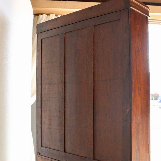 Vintage British mid-century teak cabinet with rich wood grain, simple panel doors, and sturdy rectangular form.