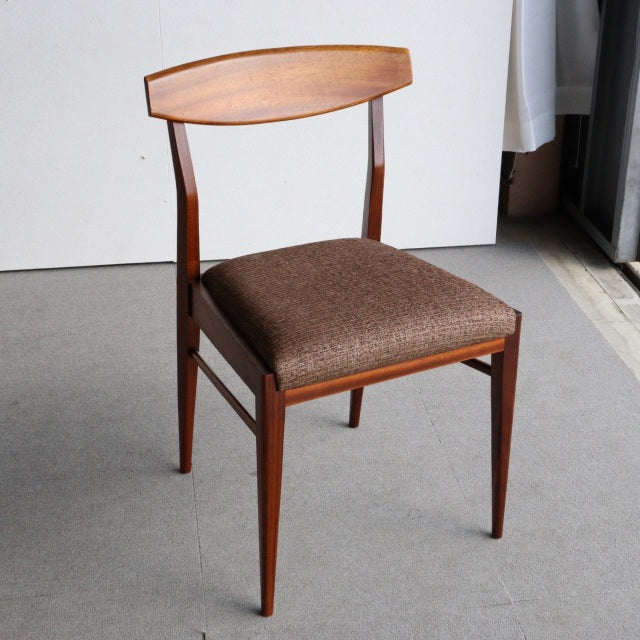 Vintage McIntosh mid-century dining chair in teak with gently curved backrest and brown upholstered seat, sleek tapered legs.