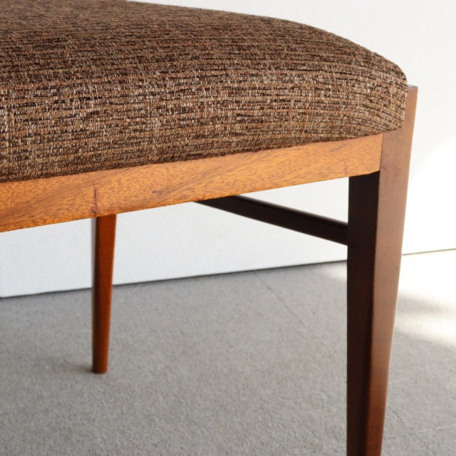 Mid-century British teak dining chair by McIntosh with tapered legs and textured brown fabric seat.