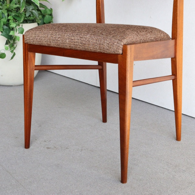 Mid-century British McIntosh dining chair in vintage teak with tapered legs and textured brown upholstered seat.