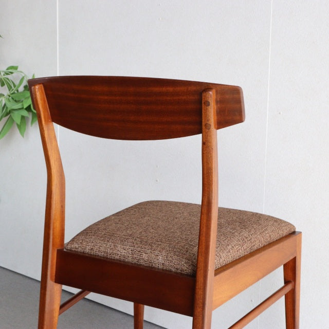 Vintage McIntosh teak dining chair with mid-century British design, curved backrest, and brown upholstered seat.