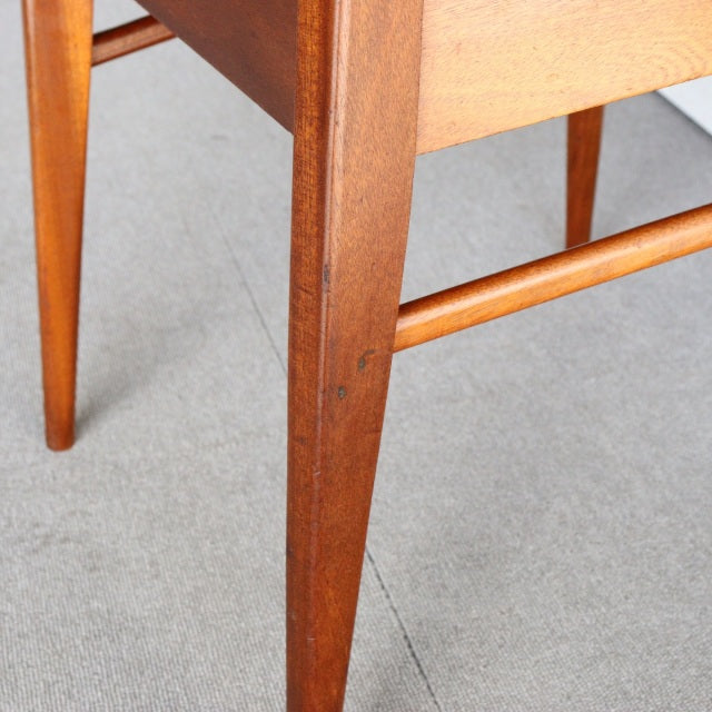 Mid-century vintage teak dining chair leg with visible wood grain and slender British design from McIntosh.