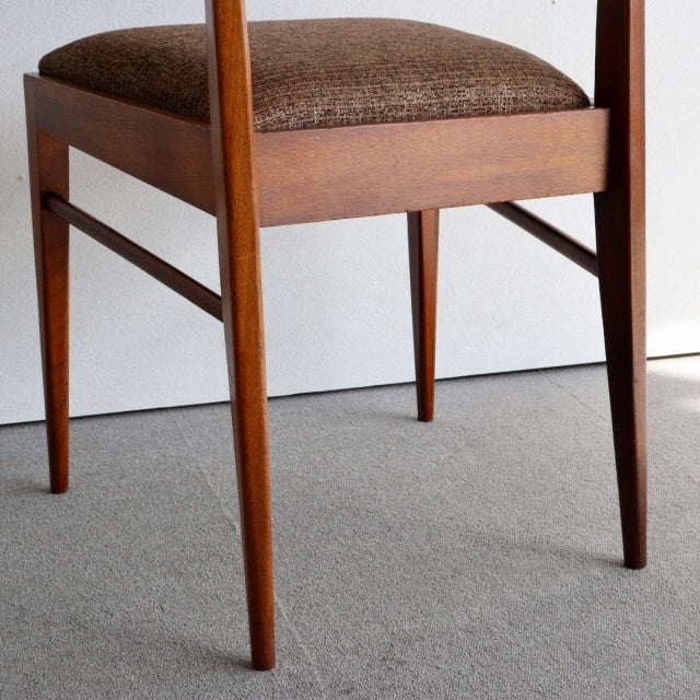 Mid-century British McIntosh dining chair in vintage teak with tapered legs and textured brown fabric seat.