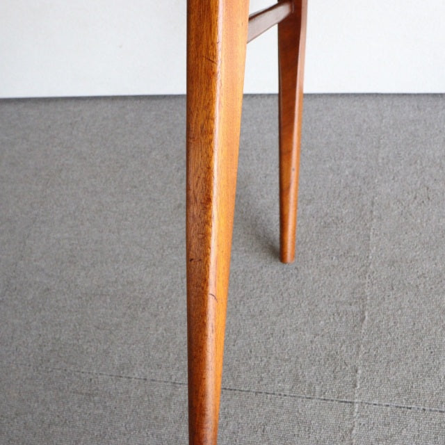 Mid-century British vintage McIntosh dining chair leg in warm teak with visible wood grain and tapered design.