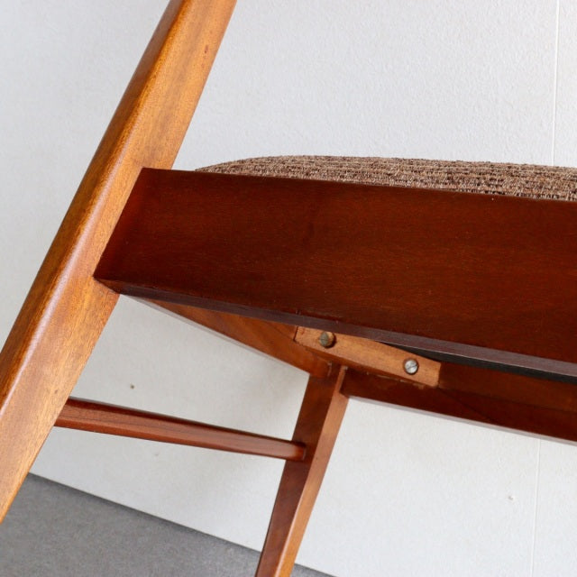 Mid-century British McIntosh dining chair in vintage teak with textured fabric seat and clean wood grain detailing.
