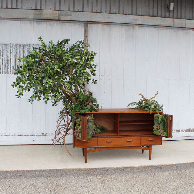 Vintage British mid-century teak sideboard by G-Plan with rich wood grain, tapered legs, and open shelving with drawers and.