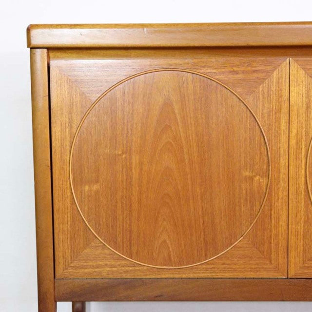 Vintage mid-century teak sideboard door with carved circular detail, British craftsmanship finish.