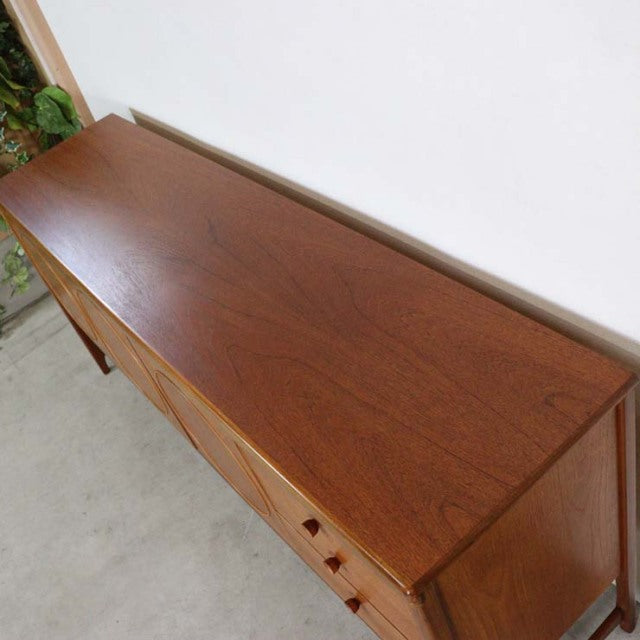Mid-century British vintage teak sideboard by Nathan with smooth wood grain and tapered legs.