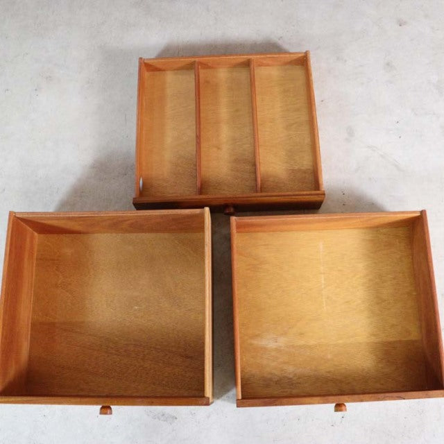 Three open teak drawers showcasing rich wood grain and smooth craftsmanship from a British mid-century Nathan sideboard.