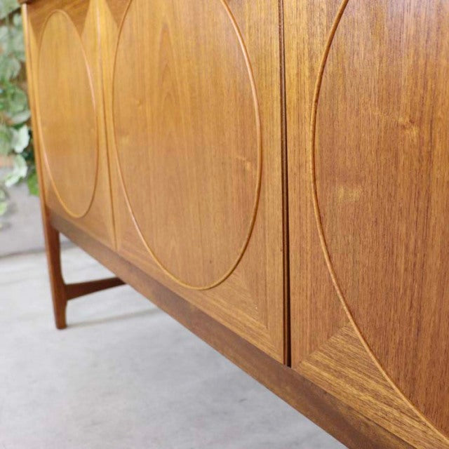 Vintage British mid-century teak sideboard by Nathan with distinctive circular wood grain patterns and tapered legs.