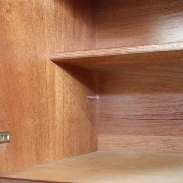 Mid-century British teak sideboard interior showing rich wood grain and smooth shelf surfaces from Nathan vintage furniture.